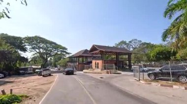 Manzaralı hayvanat bahçesi girişinden geçen arabalar.