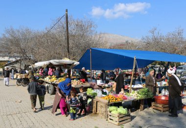 OVAKENT,HATAY,TURKEY-DECEMBER 10:Unidentified Uzbek and Afghan Immigrants buying fruit and vegetables at Local Farmers Market. December 10,2016 in Ovakent, Hatay, Turkey