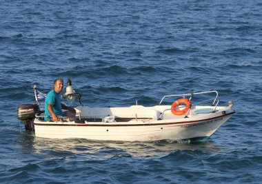 CHIOS,GREECE-JULY 11:Unidentified Greek Man enjoying Day with his Boat. July 11,2010 in Chios, Greece