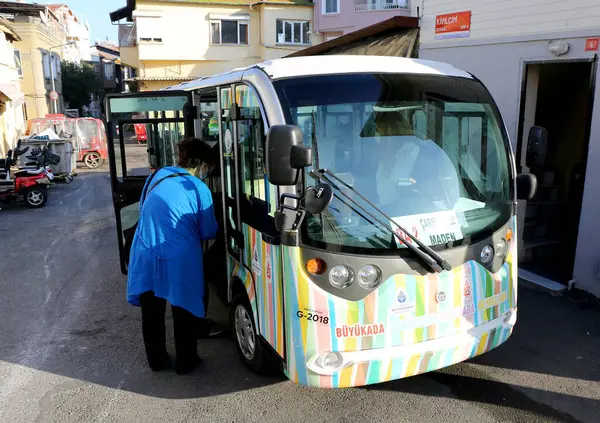 stock image BUYUKADA, ISTANBUL, TURKEY-NOVEMBER 05,2021:Unidentified People getting on the Electric Public Transportation to  travel in the island