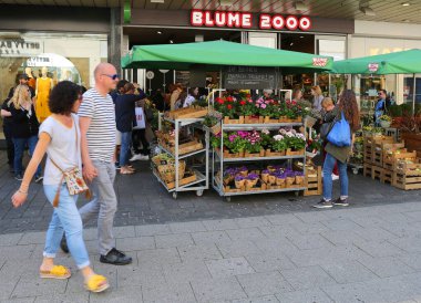 BIELEFELD, GERMANY-APRIL 20,2019:People buying flower and plants from a Popular  flower shop Blume 2000 clipart