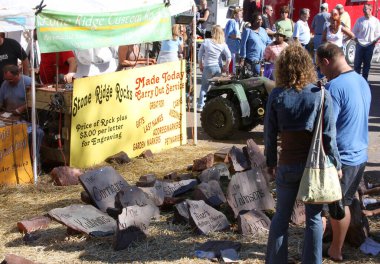 ROCKVILLE, IN, USA-OCTOBER 21,2007:Unidentified People buying a Rock with engraving at The Mansfield Covered Bridge Festival clipart