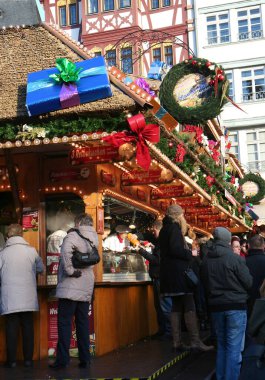 FRANKFURT, GERMANY-DECEMBER 15,2013:Unidentified People buying food at Christmas Market at Romer clipart