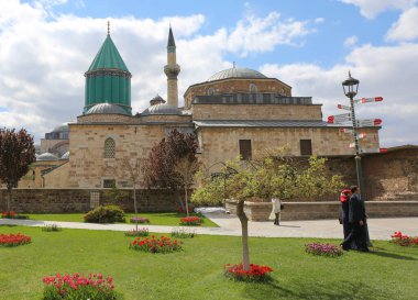 Konya, Turkey-April 23,2017:Unidentified People walking at The Garden of Mevlana Museum with Tulips in a Beautiful Spring Day clipart