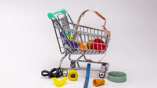 Macro Stop Motion Plastic Rubbish Waste Items Building Shopping Trolley — Stock Video