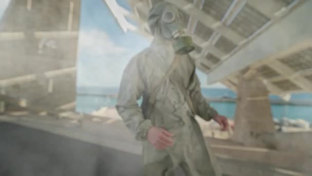 カメラに向かって驚異的な化学ガス攻撃中のガススーツの男 — ストック動画