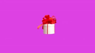 A gift box with red bow spinning against pink background
