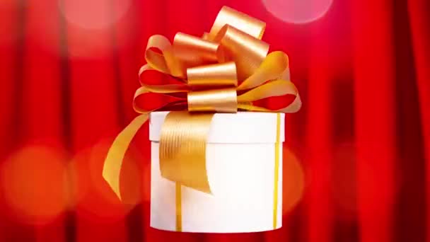Gift Box Gold Bow Spinning Red Curtain Background — Video Stock