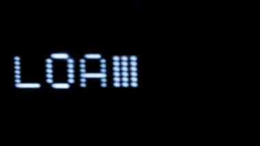 Old style computer typeface writing loading word on screen