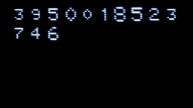 Old style computer typeface writing random numbers on screen