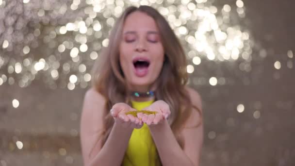 Pretty Woman Blows Sparkling Gold Confetti Slow Motion — Wideo stockowe