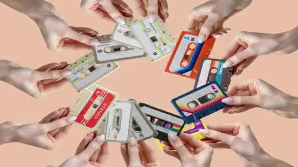 Many Hands Holding Retro Cassette Tapes Made Circular Pattern — Vídeos de Stock
