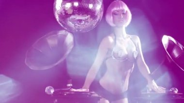 Fashionable beautiful female dj playing with turntables