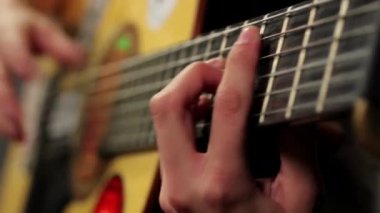 Cool woman plays guitar closeup