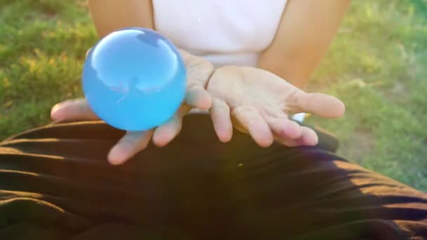 Woman Plays Contact Juggling Glass Transparent Ball — Vídeo de Stock