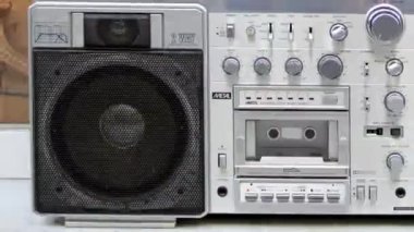 A stopmotion of a retro stereo ghettoblaster in different urban locations