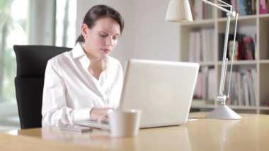 A female business woman working on laptop