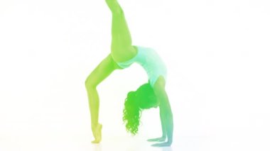 Amazing female yoga instructor moving between poses with soft colourful lights ovelrayed