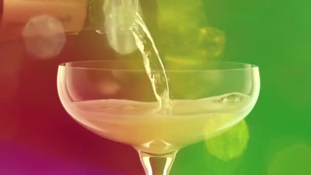 Pouring Champagne Glass Colourful Overlayed Lights — Vídeo de stock