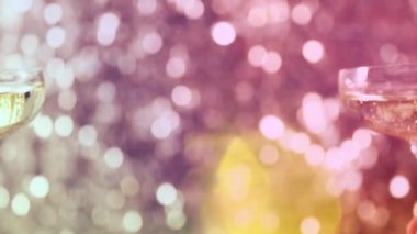 Two hands holding champagne in a glasses and making a cheers