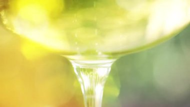 Champagne in a glass against sparkling golden background