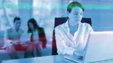 A female business woman and Blurred team members in the background with technology code overlayed