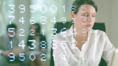 A female business woman and Blurred team members in the background with technology code overlayed