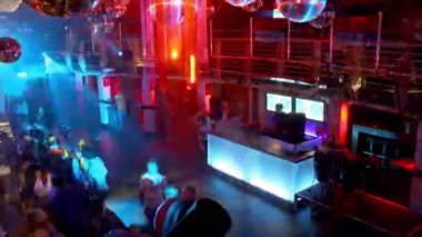 A timelapse of a night club dancefloor filling up with people 