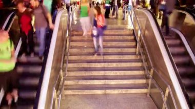 Crowds of people going up and down the las ramblas subway entrance in barcelona spain.