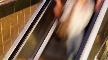 Crowds of people going up and down the las ramblas subway entrance in barcelona spain.