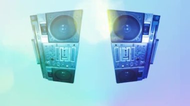 A ghettoblaster stereo spinning with colourful lights overlayed