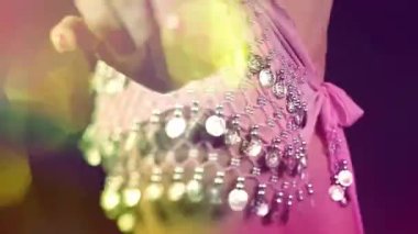 A dancer with a sparkling skirt and overlayed disco lights