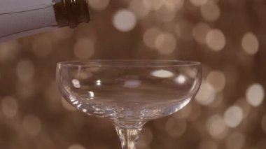 Pouring Champagne into a glass in slow motion