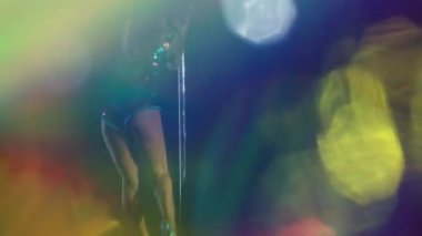 A female pole dancer with overlayed disco lights 