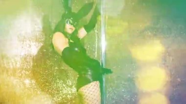 A female pole dancer with overlayed disco lights 