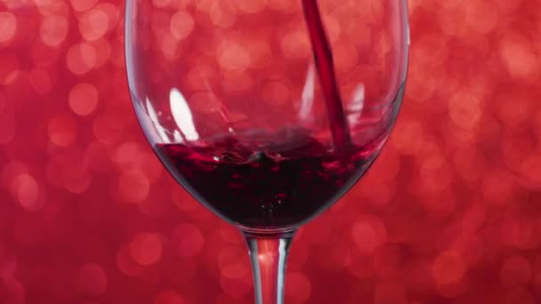 Pouring Red Wine Glass Red Sparkling Background — Stok video