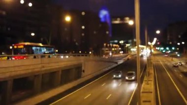 A timelapse view of a busy underpass in barcelona at night with a rush of vehicle lights