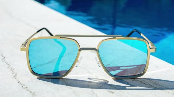 Óculos Sol Espelhados Lado Uma Piscina — Vídeo de Stock