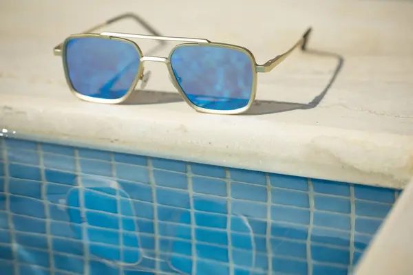 镜像太阳镜在游泳池旁边 — 图库照片
