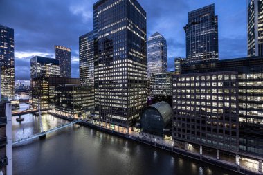 the skyline of canary wharf, london docklands, london england at night clipart