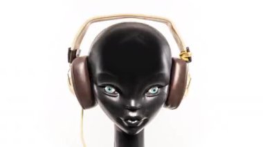 Retro kulaklıkları değişen bir mankenin stop motion videosu.