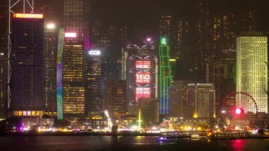 Hong Kong Central City 'nin gökdelenleri gece vakti ışıldarken kowloon limanının karşısından çekilen silueti. 