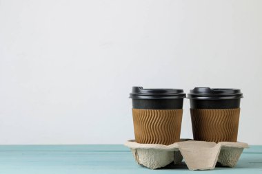 Paper cups with coffee on a blue table. coffee to go