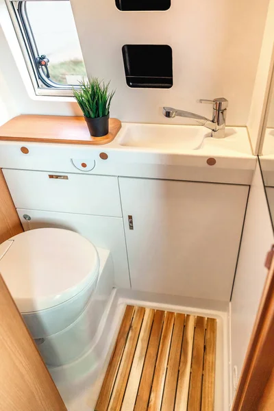 Camper van bathroom interior with toilet and sink
