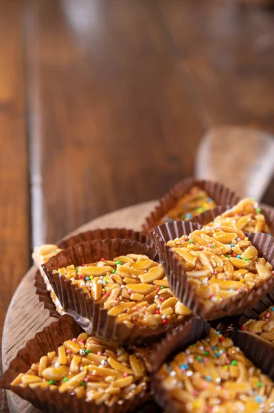 Desserts with almonds, peanuts and seeds in caramel. Traditional Sardinian sweet. Sweet squares. Almond Gateau, sarda Food, for smartphones and social networks. Copy space. Vertical