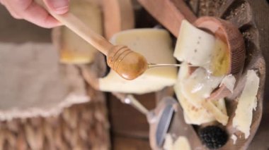 Pecorino cheese with truffle, traditional Italian sheeps milk cheese with truffle. A typical product of the dairy regions of Tuscany and Sardinia. Honey and cheese. High quality HD video. Vertical 