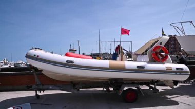 The boat is parked in the port. Sunny day at the yacht club. High quality FullHD footage