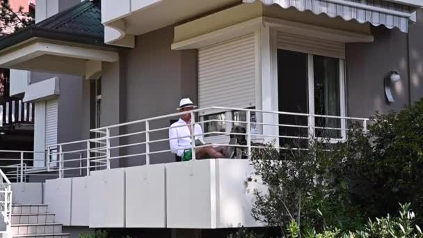 Man Resting Balcony Man Relaxing His Apartment High Quality Fullhd — Stockvideo