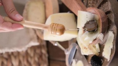 Pecorino cheese with truffle, traditional Italian sheeps milk cheese with truffle. A typical product of the dairy regions of Tuscany and Sardinia. Honey and cheese. High quality HD video. Vertical