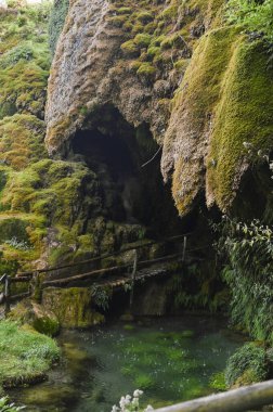 Grotto in the mountains of italy in autumn. Hills and unique places with waterfalls in the mountains. High quality photo